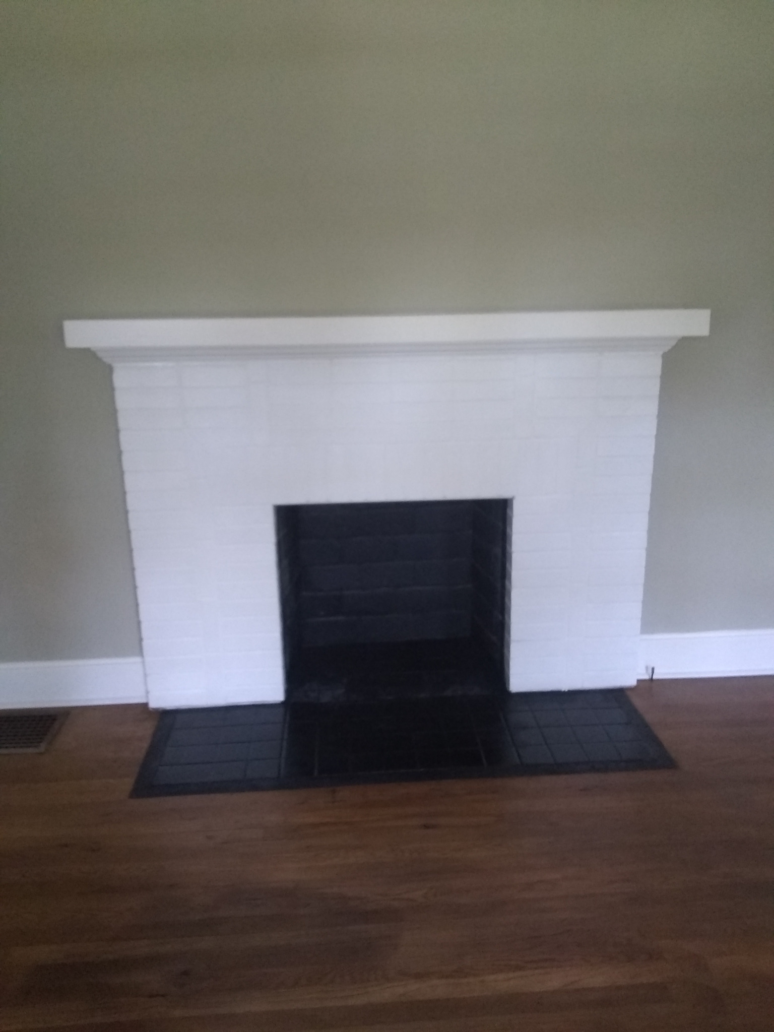 White fireplace mantel and dark hearth