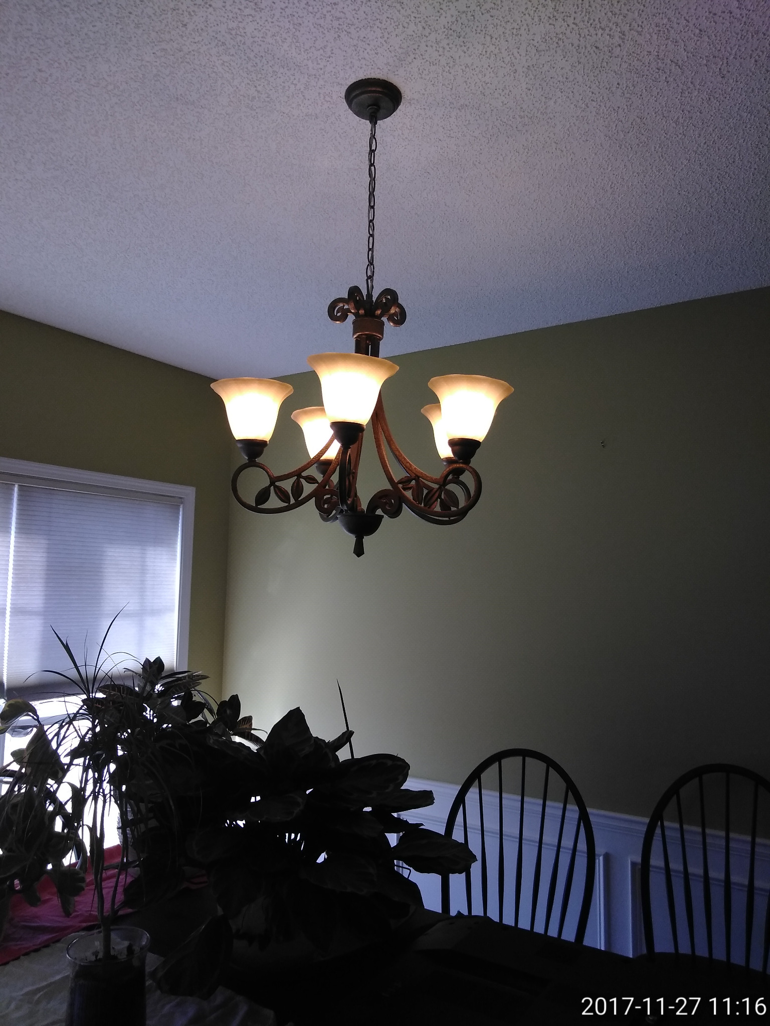 Decorative chandelier installed in a dining room